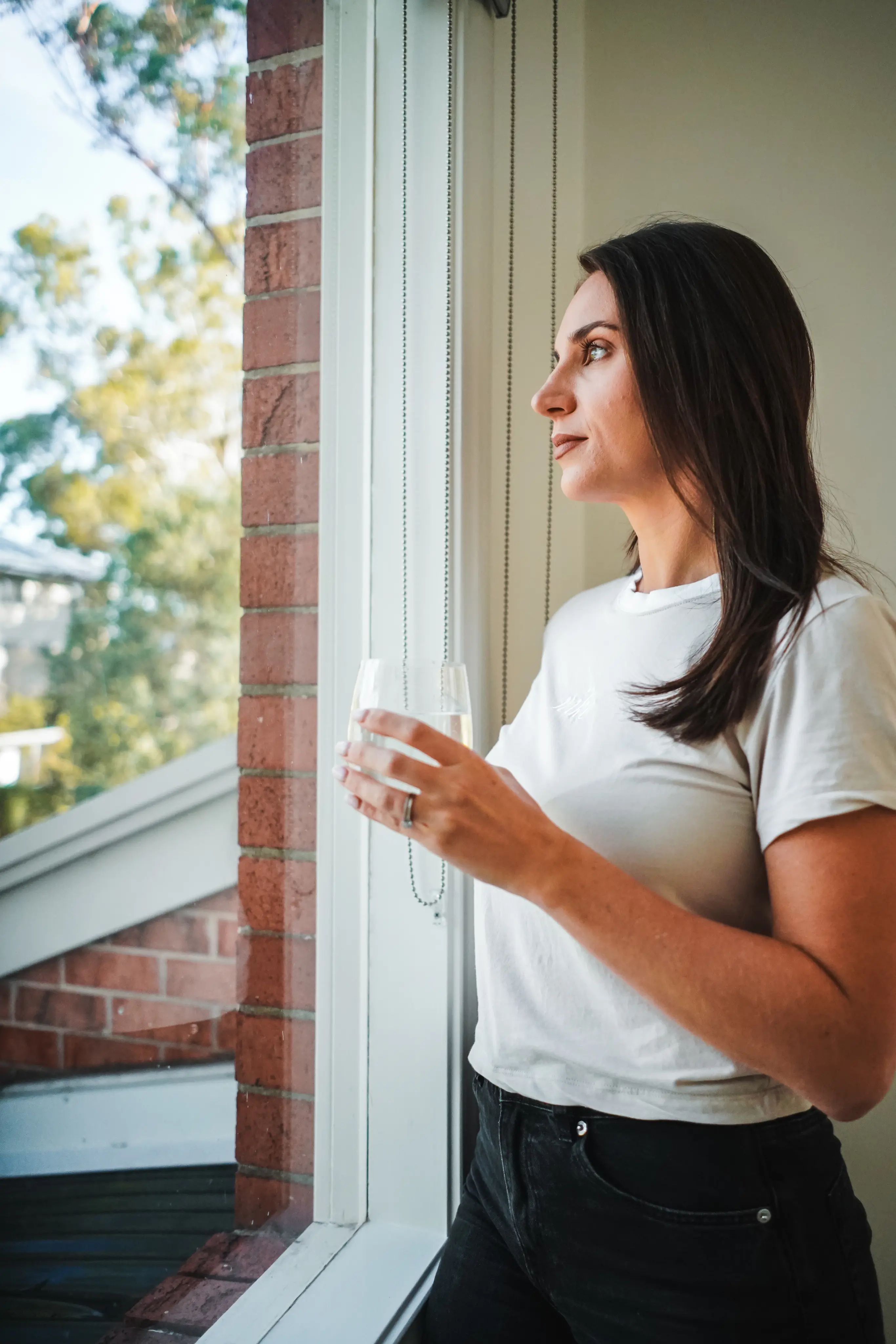 A woman drinking a glass of filtered water